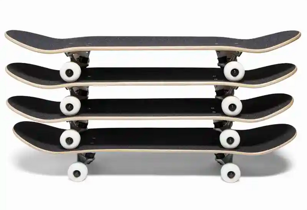 Four Complete Skateboards Stacked On Top Of Each Other