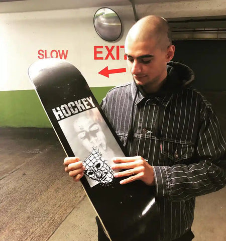 Kevin Rodrigues Holding Hockey Skateboard Deck