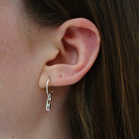 Silver Ice Skating Hoop earring in an ear