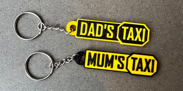keyrings with the words mum's taxi and dads taxi on them