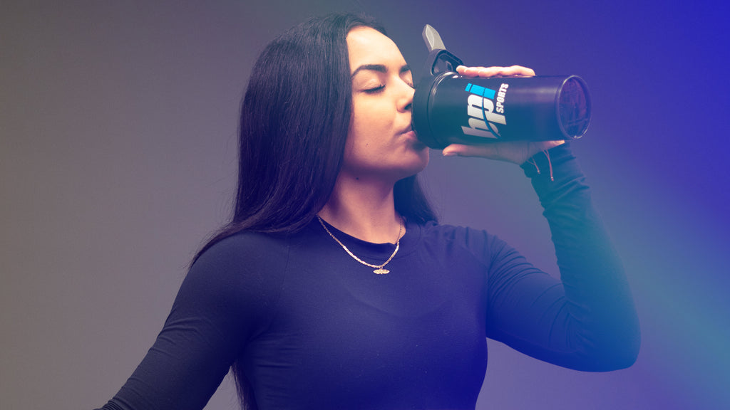 young fit girl drinking shaker cup