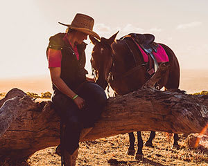 A picture of a person enjoying a horse riding experience with adrenaline