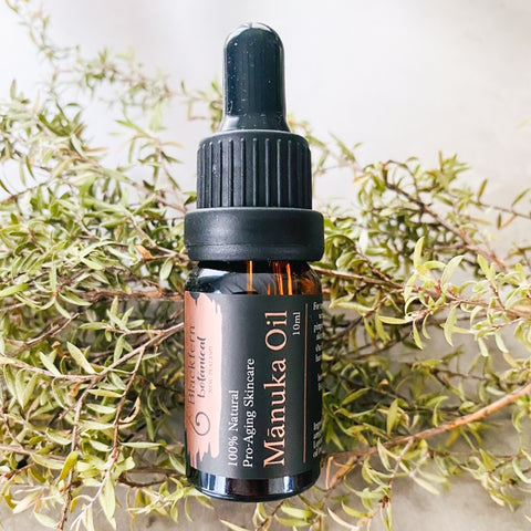 a bottle of blackfern botanical manuka skin oil 10ml with fresh manuka leaves in backdrop