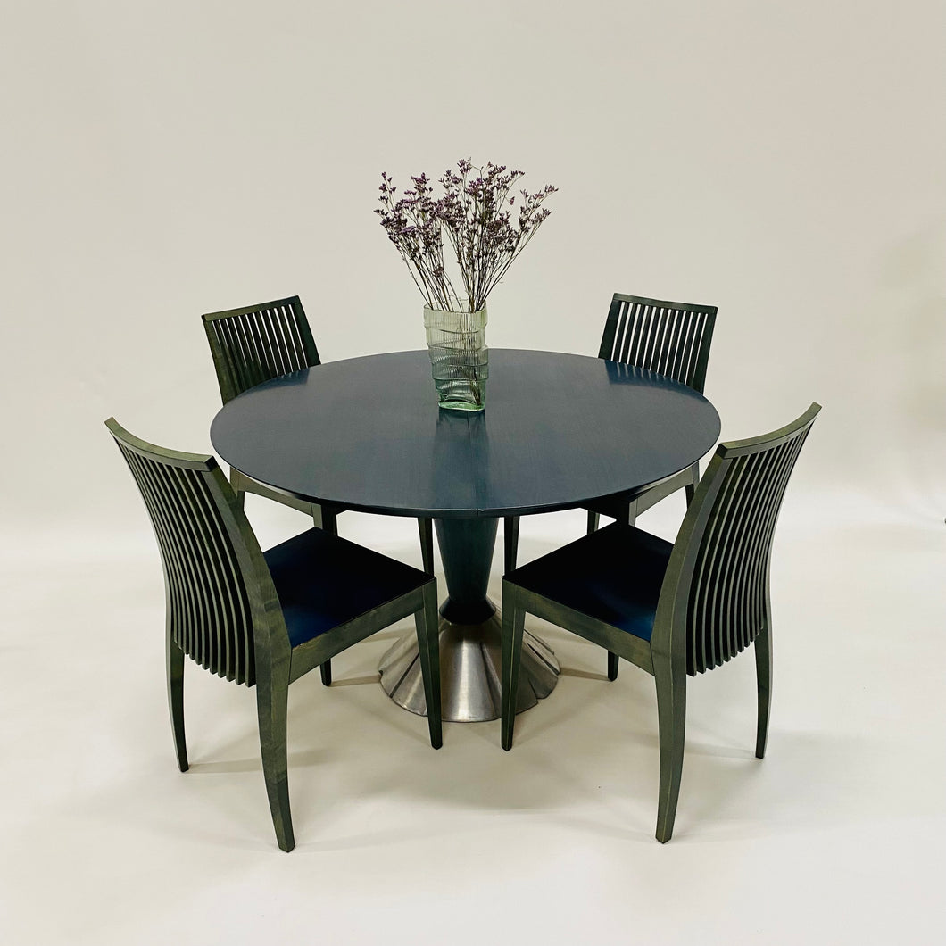 round wood dining table with four chairs