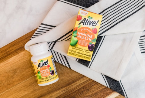 A bottle and box of Alive! Everyday Immune Health supplements on a table.