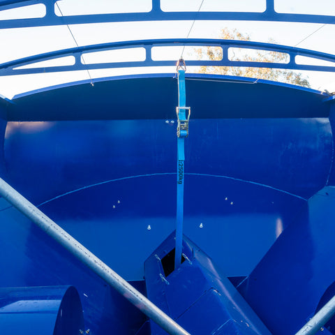 ratchet strap supporting the cross auger suspended from the rearward tarp bow
