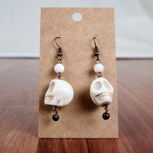 Load image into Gallery viewer, White stone skull earrings with antique copper hardware
