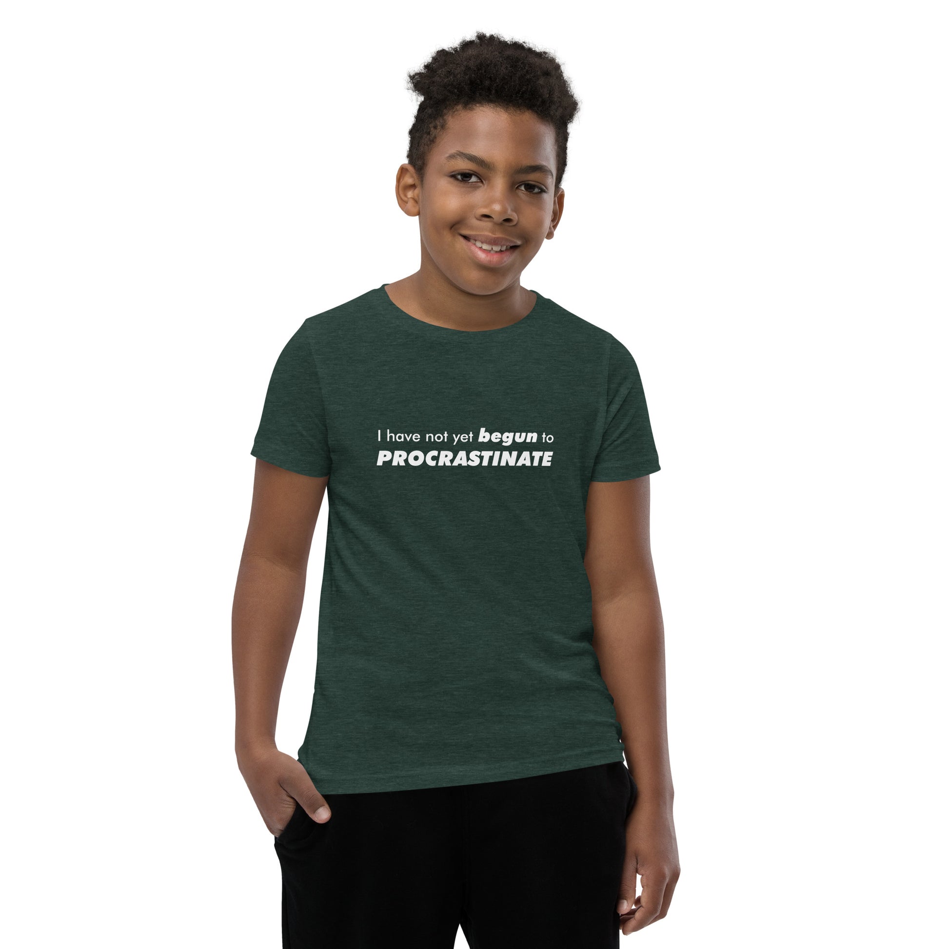 Young male model wearing Heather Forest youth t-shirt with text graphic: "I have not yet BEGUN to PROCRASTINATE"