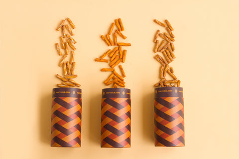 three pretzel cartons with pretzels spilling out