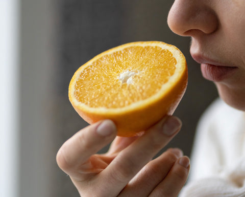 Inhaling an orange to get the therapeutic benefits of sweet orange essential oil