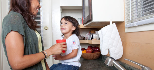 Mother drinking water with her daughter