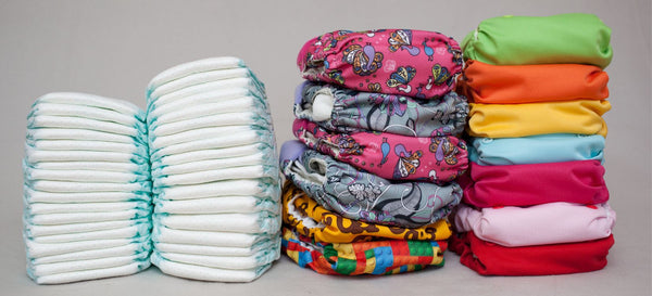 A pile of diapers versus a dozen of clothdiapers or potty training underwear.