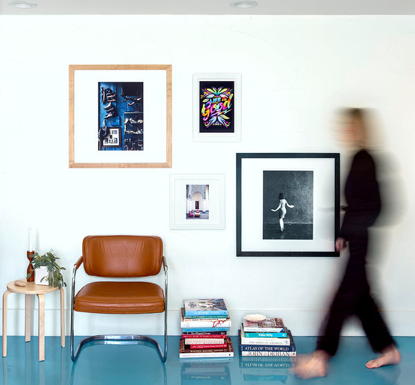 Modern interior featuring various types of wall art, including photographs, paintings, and limited-edition prints