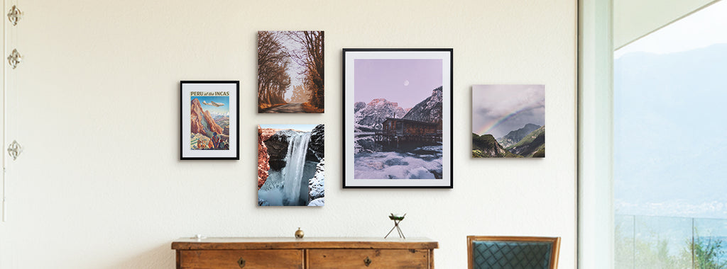 a picture of several framed pieces of wall art modern prints on an otherwise blank wall