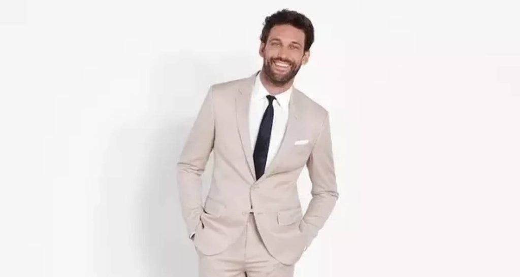 Traje beige con camisa blanca y corbata negra