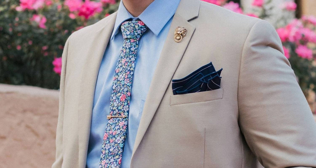 Hombre Traje beige y camisa azul y corbata de flores