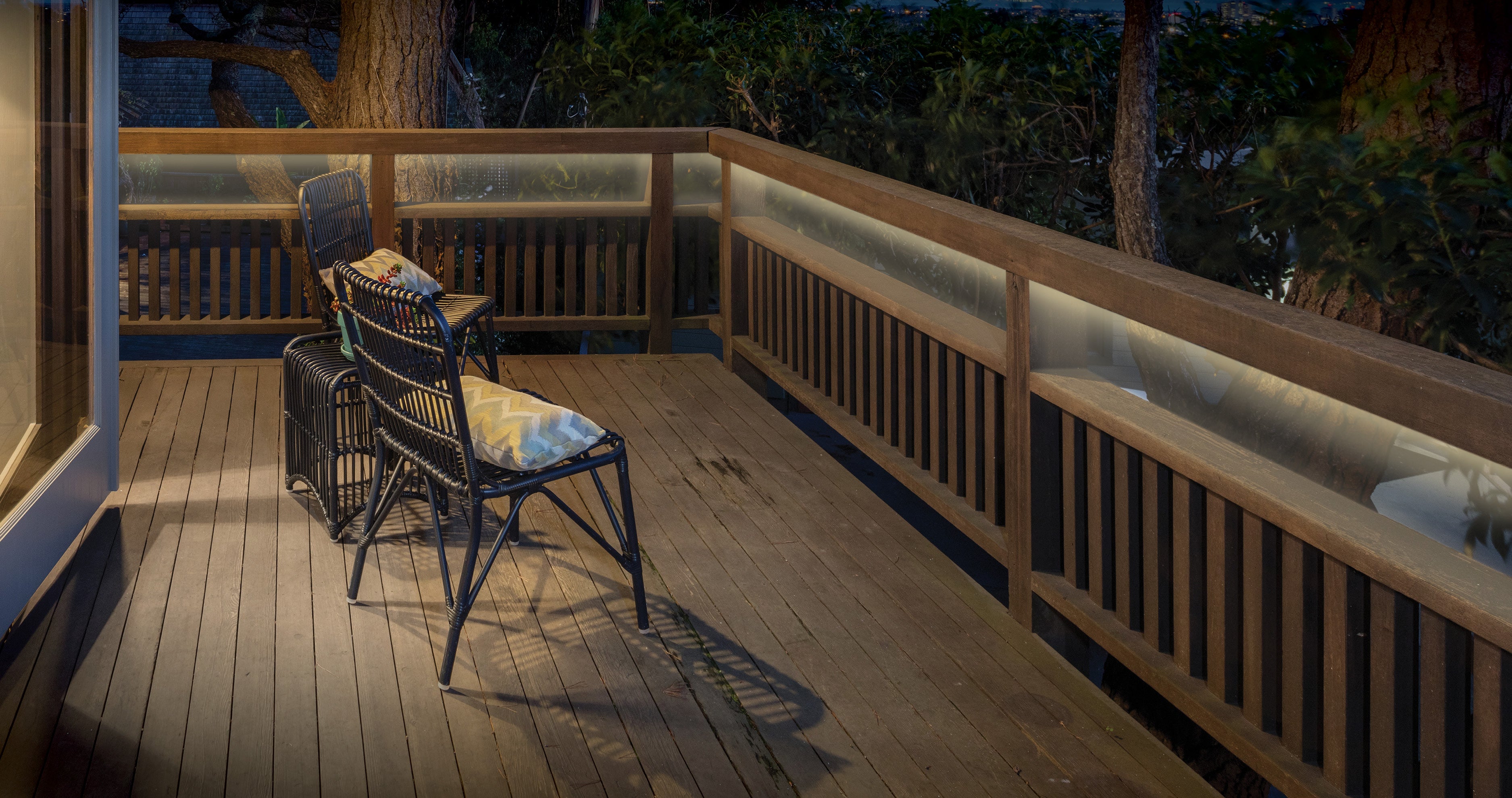 Outdoor LED tape light installed under a deck railing