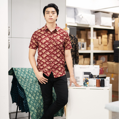 A men standing in front of sewing machine, wearing batik shirts in crimson nasi lemak by batik boutique