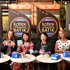 Batik Boutique's founder and a Kimberly Clark representative hold Kotex pad and Batik Boutique products.