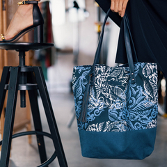 Woman holding batik tote bag in blue nautical fern, handcrafted in Malaysia.