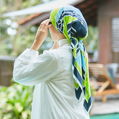 Women standing while wearing batik square scarf by Batik Boutique in design Teal Rimba