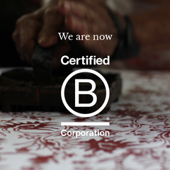 A B Corp certification granted to Batik Boutique, featuring a captivating image capturing the artistry of an artisan creating authentic batik