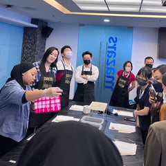 an artisan explaining the process of batik in a corporate office