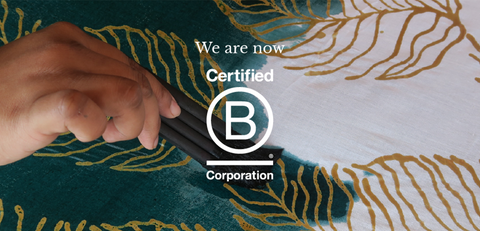 A compelling image showcasing the B Corp certification awarded to Batik Boutique, with the intricate process of crafting authentic batik as a meaningful backdrop, symbolizing their commitment to sustainable and ethical practices