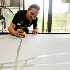 Batik artist making batik using brush and wax