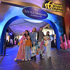 a family picture in front of gsc event for disney's little mermaid premiere in collaboration with batik boutique