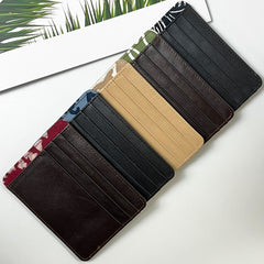 a row of card holder wallets in multiple authentic batik designs and leather against a neutral background