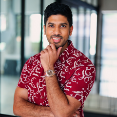 a male model posing in a red batik shirt in the pattern crimson diwanie that's perfect for chinese new year