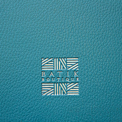 Dive into the exquisite details with a close-up photo capturing the precision and elegance of a logo expertly embossed on a PU leather journal, showcasing the seamless fusion of artistry and branding