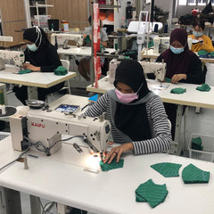 seamstresses in the process of sewing batik
