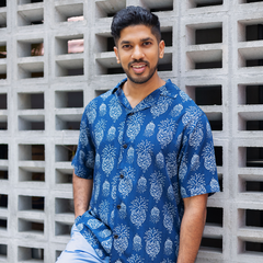 a man posing in batik shirt in pineapple motif for batik boutique