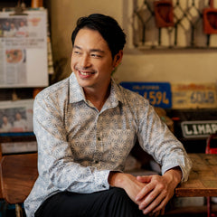 an image of a male model posing and looking to the side while wearing a genuine batik shirt in the pattern grey firework