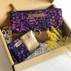 an image of an organizer set made of genuine batik in the pattern purple bintik with props accompanying the batik pouch and card holder wallet