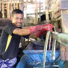 an artisan in the process of making batik