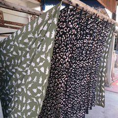 batik boutique dinosaur and leopard prints drying fabric