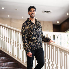 batik boutique - men in long sleeve batik shirt in black diwanie at the stairs