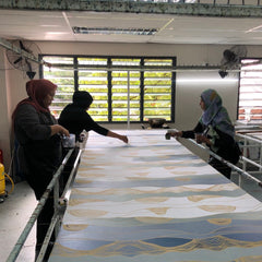 batik boutique in-house artisans dyeing color on fabric