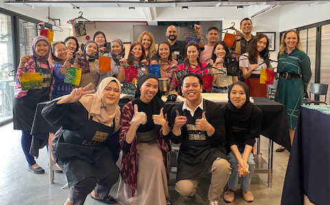 a group photo in a batik workshop for a team building activity for corporate workers