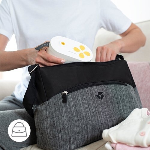 woman putting a breast pump in her diaper bag for easy travel