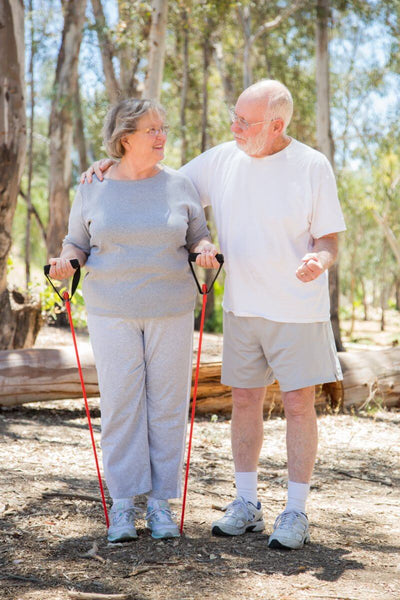 Senior couple exercising outdoor to help lower their blood sugar levels