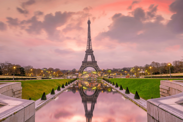 View of the Eiffel Tower in Paris, France as dusk with pink skies