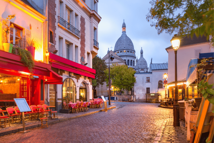 The Place du Tertre with tables outside a cafe and the Sacre-Coeur, Montmartre in Paris, France