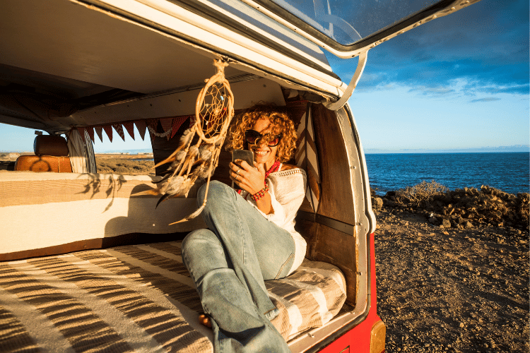 Woman sitting in campervan during the golden hour, European van life, travelling around Europe this summer in a van