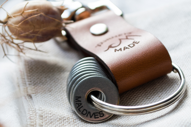 Tan leather travel keyring with the engraved Maldives token showing, perfect travel gift idea