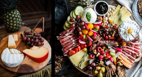 Cheese board with charcuterie, grapes, and olives for a wine tasting.