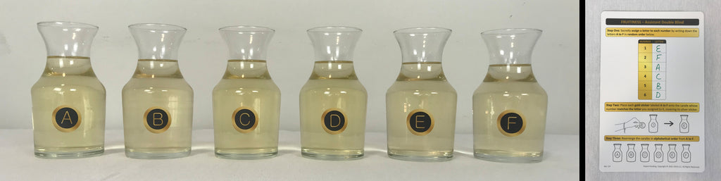 Lettered carafes for blind tasting and guest instruction card for tracking wines.